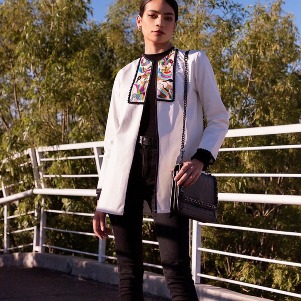 White long jacket with multicolor patterns embroidered.